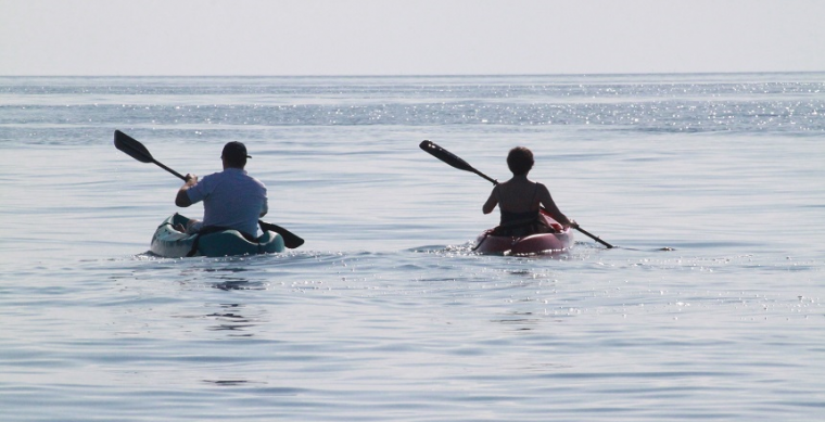 Connection during social distancing represented by two people in separate kayaks